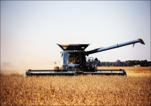 A harvesting operation kicks up dust in rural Carr