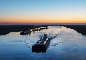 Dusk shot of barges traversing a short canal that connects the Sabine Pass