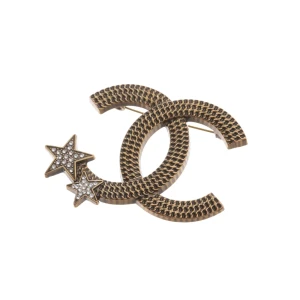 Chanel Broschen (gold) Metall / Glas - gebraucht, mit CC-Logo & Stern-Applikationen