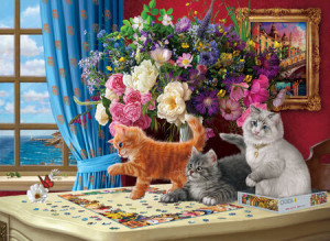 Niedliche Katzenkinder beim Puzzlen