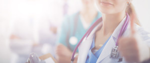 Fototapeta Medycyna Attractive female doctor in front of medical group
