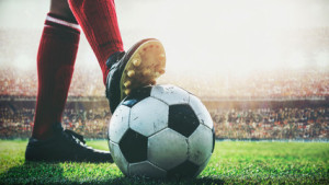 Fototapeta Piłka nożna feet of soccer player tread on soccer ball for kick-off in the stadium