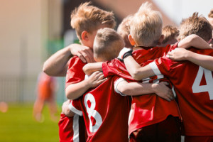 Fototapeta Sport Kids Play Sports Game. Children Sporty Team United Ready to Play Game. Children Team Sport. Youth Sports For Children. Boys in