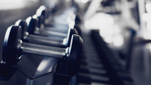 Fototapeta Siłownia gym interior background of dumbbells on rack in fitness and workout room