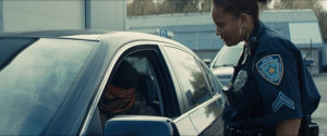 Fototapeta Policja African-American black driver is being pulled off by mixed-race female police officer. Documents check, speeding ticket