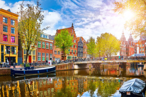 Fototapeta Amsterdam Channel in Amsterdam Netherlands houses river Amstel landmark