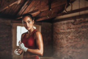 Fototapeta Boks Female in shed preparing for boxing