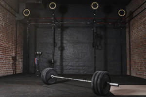 Fototapeta Siłownia Crossfit athlete lifting barbell overhead at the gym. Shirtless man doing functional training. Practicing powerlifting.