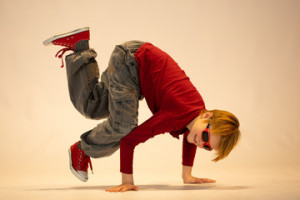 Fototapeta Breakdance young dancer in breakdance position, child in a unique dance pose
