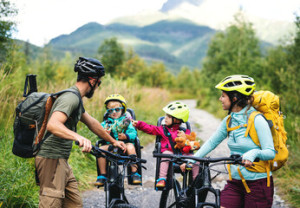 Fototapeta Kolarstwo Family with small children cycling outdoors in summer nature, resting.